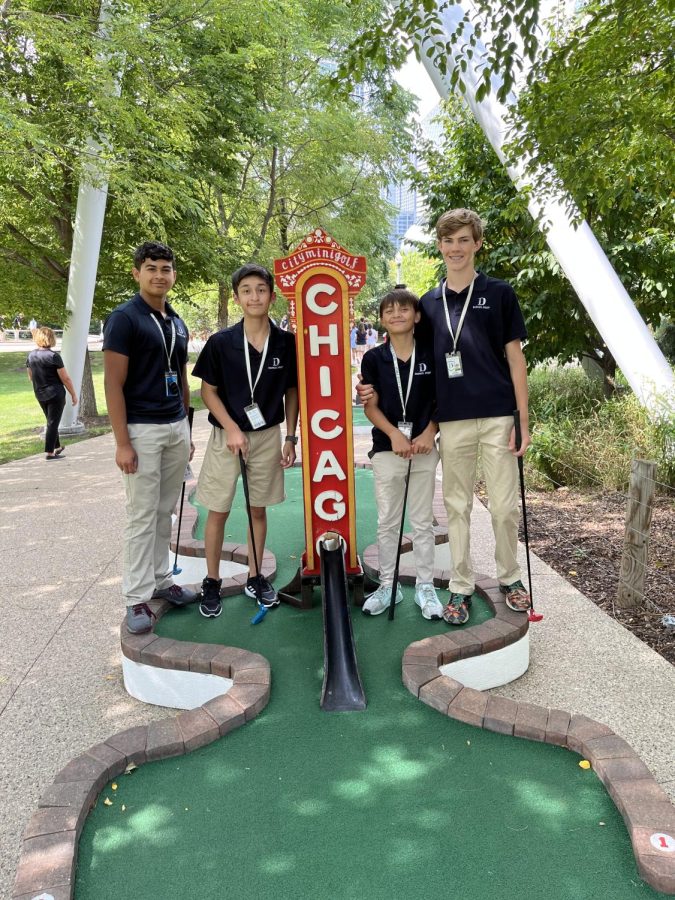 Student participants in the Putt Putt colloquium pause during a game.