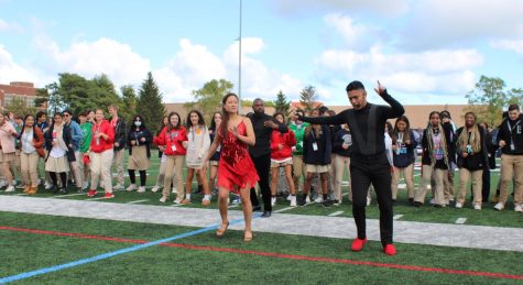 Members of Latin Street Dance lead students in learning dance moves at the Hispanic Heritage Assembly. (Photo courtesy of Cup of Joe.)